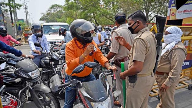 Police stop commuters and urge them to stay home during the nationwide lockdown to prevent spread of Covid-19, in Prayagraj on Monday. (ANI Photo) Police stop commuters and urge them to stay home during the nationwide lockdown to prevent spread of Covid-19, in Prayagraj on Monday. (ANI Photo)