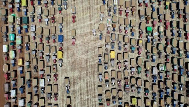 Farmers line up their tractors carrying wheat grain at a wholesale market at Majholi Tehsil village, some 45 km from Jabalpur on April 21. (Uma Shankar Mishra / AFP) Farmers line up their tractors carrying wheat grain at a wholesale market at Majholi Tehsil village, some 45 km from Jabalpur on April 21. (Uma Shankar Mishra / AFP)