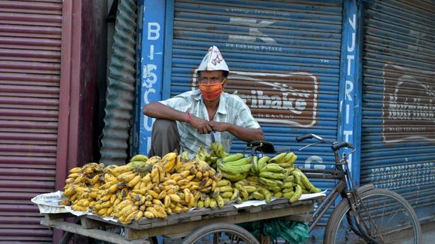 A vendor wearing a facemask with his cart of bananas in Siliguri on April 20. (Diptendu Dutta / AFP) A vendor wearing a facemask with his cart of bananas in Siliguri on April 20. (Diptendu Dutta / AFP)
