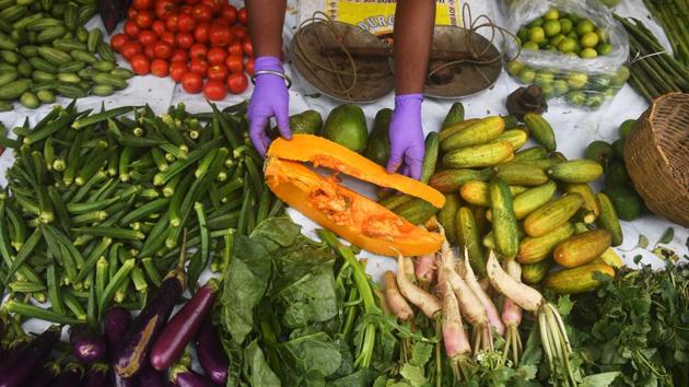 A vegetable vendor arranges his stock as he waits for customers in Kolkata on April 21. Surprisingly, Eastern India had not witnessed a rise in prices as much as the rest of the country up until a few days ago. (Dibyangshu Sarkar / AFP) A vegetable vendor arranges his stock as he waits for customers in Kolkata on April 21. Surprisingly, Eastern India had not witnessed a rise in prices as much as the rest of the country up until a few days ago. (Dibyangshu Sarkar / AFP)