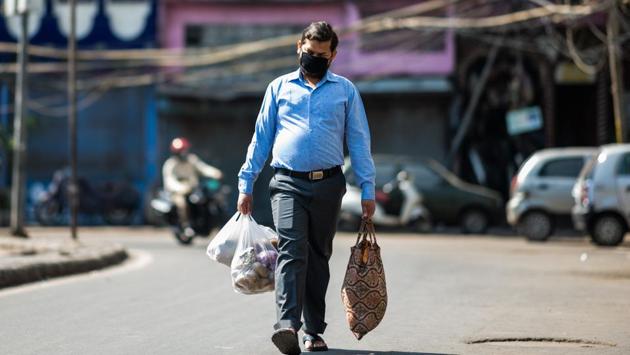 A man walks along a street with groceries during a government-imposed lockdown as a preventive measure against the spread of the coronavirus (COVID-19) in New Delhi on April 21. (Jewel Samad / AFP) A man walks along a street with groceries during a government-imposed lockdown as a preventive measure against the spread of the coronavirus (COVID-19) in New Delhi on April 21. (Jewel Samad / AFP)