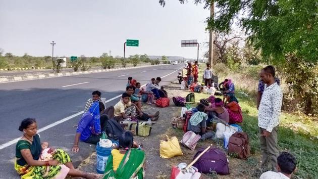 Migrant workers sit on the side of the road in Nagpur during their journey on foot from Telangana to reach their native places during coronavirus lockdown, on Monday. (ANI Photo) Migrant workers sit on the side of the road in Nagpur during their journey on foot from Telangana to reach their native places during coronavirus lockdown, on Monday. (ANI Photo)