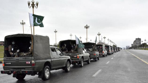 Pakistan's national flags flutter on an Army convey patrolling during a partial lockdown after Pakistan shut all markets, public places and discouraged large gatherings amid an outbreak of coronavirus disease (COVID-19), in Islamabad.(REUTERS)