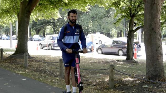 Cheteshwar Pujara rides an electric scooter as leaves a training session.(AP)