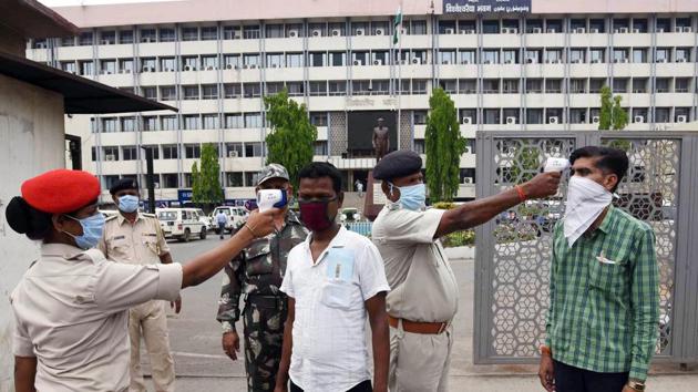 A security personnel conducts thermal screening of government officials before they enter the state secretariat building in Patna on Monday. (ANI Photo) A security personnel conducts thermal screening of government officials before they enter the state secretariat building in Patna on Monday. (ANI Photo)