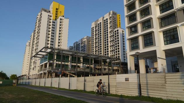A cyclist rides past a housing construction site in the Punggol area of Singapore, where activity has been stalled due to circuit-breaker measures against the coronavirus outbreak, on April 20, 2020. Singapore reported a record 1,426 new coronavirus cases on Monday, mostly among foreign workers, pushing its total number of confirmed infections to 8,014. (Wei Leng Tay / Bloomberg) A cyclist rides past a housing construction site in the Punggol area of Singapore, where activity has been stalled due to circuit-breaker measures against the coronavirus outbreak, on April 20, 2020. Singapore reported a record 1,426 new coronavirus cases on Monday, mostly among foreign workers, pushing its total number of confirmed infections to 8,014. (Wei Leng Tay / Bloomberg)