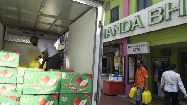 People load food destined for migrant workers onto a truck during a partial lockdown imposed due to the coronavirus in the Little India area of Singapore. Over half of the 43 registered dormitories have reported active viral clusters. At least 18 of the dormitories were declared isolation areas where workers have been quarantined. (Wei Leng Tay / Bloomberg) People load food destined for migrant workers onto a truck during a partial lockdown imposed due to the coronavirus in the Little India area of Singapore. Over half of the 43 registered dormitories have reported active viral clusters. At least 18 of the dormitories were declared isolation areas where workers have been quarantined. (Wei Leng Tay / Bloomberg)