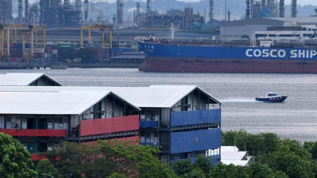A Police Coast Guard boat patrols along the Johor Strait next to the S11 Punggol dormitories that house foreign workers and have been made into an isolation area on April 21. The city-state now has the highest number of cases in Southeast Asia. About 3,000 cases have been reported in just the past three days. (Roslan Rahman / AFP) A Police Coast Guard boat patrols along the Johor Strait next to the S11 Punggol dormitories that house foreign workers and have been made into an isolation area on April 21. The city-state now has the highest number of cases in Southeast Asia. About 3,000 cases have been reported in just the past three days. (Roslan Rahman / AFP)