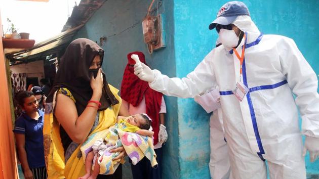 Slum dwellers being checked by medics for Covid-19, at Vallabh Nagar locality, in Bhopal on Monday. (ANI Photo) Slum dwellers being checked by medics for Covid-19, at Vallabh Nagar locality, in Bhopal on Monday. (ANI Photo)