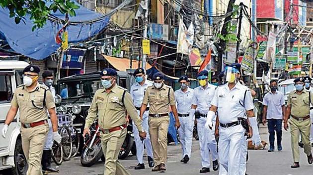 Police personnel wearing masks and face shields conduct a flag march in Kolkata’s Rajabazar on Tuesday. (ANI) Police personnel wearing masks and face shields conduct a flag march in Kolkata’s Rajabazar on Tuesday. (ANI)