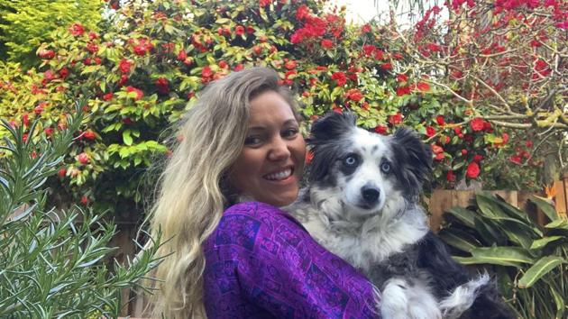 The image shows Emilie Talermo hugging her dog. (AP) The image shows Emilie Talermo hugging her dog. (AP)
