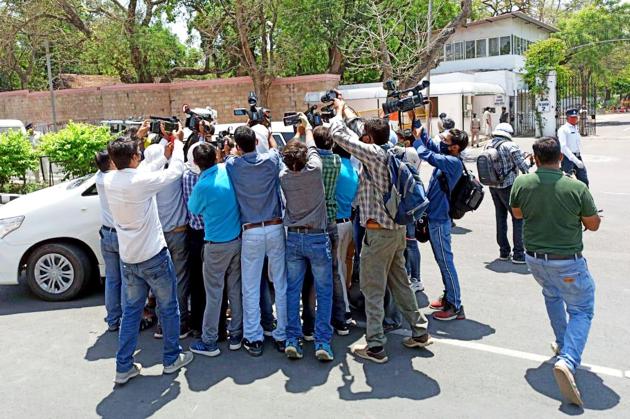 Cameramen and reporters were seen in a huddle while jostling for a news bite after the oath ceremony outside Raj Bhawan in Bhopal on Tuesday. (ANI Photo) Cameramen and reporters were seen in a huddle while jostling for a news bite after the oath ceremony outside Raj Bhawan in Bhopal on Tuesday. (ANI Photo)