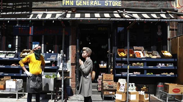 Derek Tigue (L), talks with neighbour Geraldine Johns in front of the FMN General Store. “It’s a small service we’re providing to the neighbourhood. We owe a huge gratitude to the community for being there for us. We just want to keep our restaurants alive, and keep our doors open,” Tigue said. (Kathy Willens / AP) Derek Tigue (L), talks with neighbour Geraldine Johns in front of the FMN General Store. “It’s a small service we’re providing to the neighbourhood. We owe a huge gratitude to the community for being there for us. We just want to keep our restaurants alive, and keep our doors open,” Tigue said. (Kathy Willens / AP)