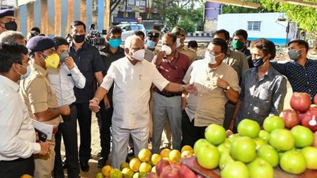 Karnataka chief minister BS Yediyurappa interacts with fruit and vegetable vendors during a nationwide lockdown in the wake of coronavirus pandemic in Bengaluru on April 12, 2020.(PTI File Photo)