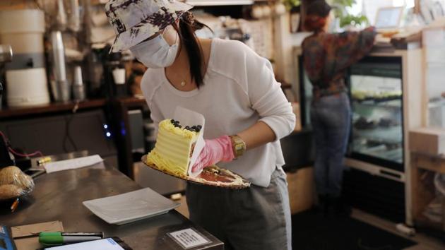 Assistant Manager Tiffany Wong on a workday work in Clementine Bakery. Wong told the AP that two of three customers purchase produce, even though they might have come for baked goods. “We’ve stopped taking cash…we’re contactless payment as much as possible. We started enforcing the five-people-at-a-time rule.” (Kathy Willens / AP) Assistant Manager Tiffany Wong on a workday work in Clementine Bakery. Wong told the AP that two of three customers purchase produce, even though they might have come for baked goods. “We’ve stopped taking cash…we’re contactless payment as much as possible. We started enforcing the five-people-at-a-time rule.” (Kathy Willens / AP)
