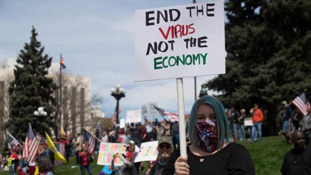 Demonstrators gather in front of the Colorado State Capitol building to protest coronavirus stay-at-home orders during a "ReOpen Colorado" rally in Denver, on April 19. (Jason Conolly / AFP) 