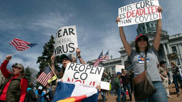 Demonstrators in front of the Colorado State Capitol building in Denver, on April 19. A bipartisan majority of Americans - 88% of Democrats and 55% of Republicans - want to continue to shelter in place despite the impact on the economy, according to a Reuters/Ipsos poll released on Tuesday. (Jason Connolly / AFP) 