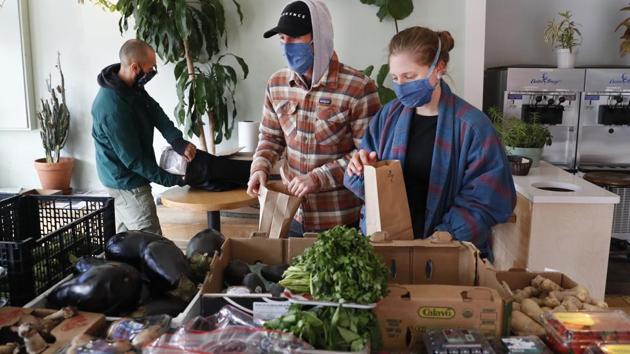 Justin Whitkin (C), and Elizabeth Boileau, (R), shop for produce at Clementine Bakery. “So far, people are really patient, and no one has complained about having to wait outside,” Wong said, adding that customers often express appreciation for small stores being open, saving them trips to crowded supermarkets. (Kathy Willens / AP) Justin Whitkin (C), and Elizabeth Boileau, (R), shop for produce at Clementine Bakery. “So far, people are really patient, and no one has complained about having to wait outside,” Wong said, adding that customers often express appreciation for small stores being open, saving them trips to crowded supermarkets. (Kathy Willens / AP)