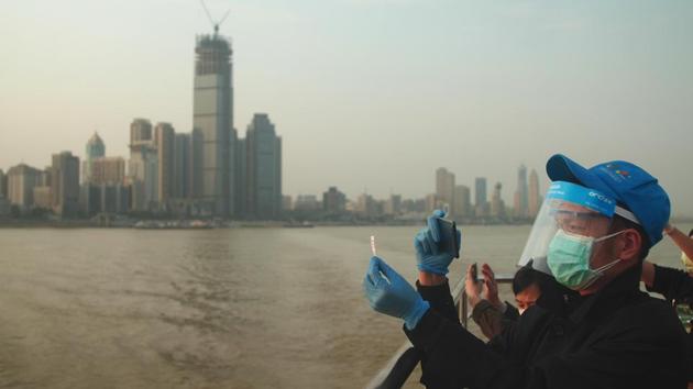A man snaps a photo of his ticket to commemorate his first ferry ride across the Yangtze River in Wuhan in central China's Hubei province after a 76-day Covid-19 quarantine ended in the city on April 8. (AP Photo) A man snaps a photo of his ticket to commemorate his first ferry ride across the Yangtze River in Wuhan in central China's Hubei province after a 76-day Covid-19 quarantine ended in the city on April 8. (AP Photo)