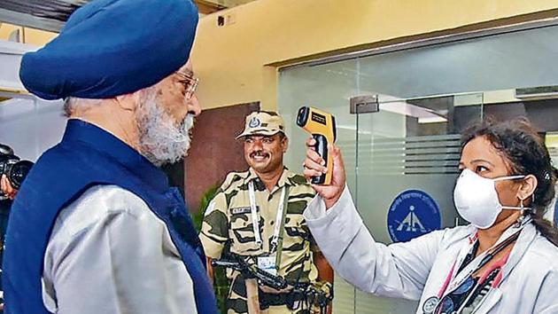 Union civil aviation minister Hardeep Singh Puri being screened by a health worker in Hyderabad on March 14.(PTI)