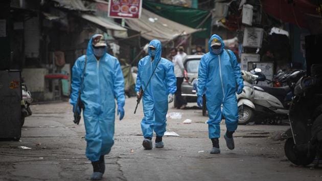 Paramilitary staff wearing Personal Protective Kits patrolling inside contaminated zones .(HT Photo/Sanchit Khanna)