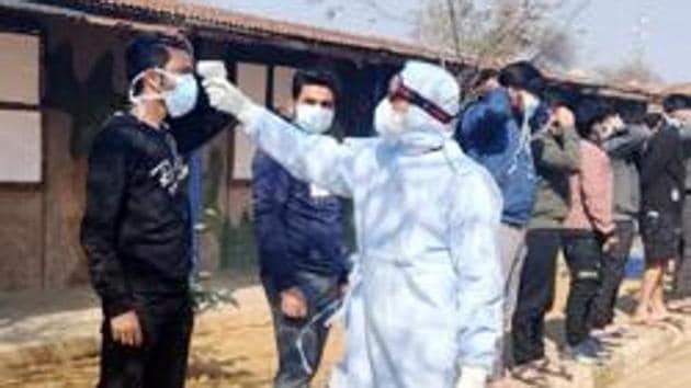 A medical staff scans the temperature of Indian National who arrived from coronavirus-hit Wuhan, put for medical observation, at quarantine center, in Manesar on Feb 3, 2020. (ANI)