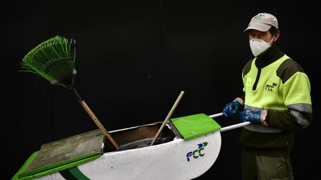 Public cleaner Jose Bataller poses for a photograph . Uncertainty reigns for the future of these workers as well, with the country heading for a likely recession. (Alvaro Barrientos / AP)