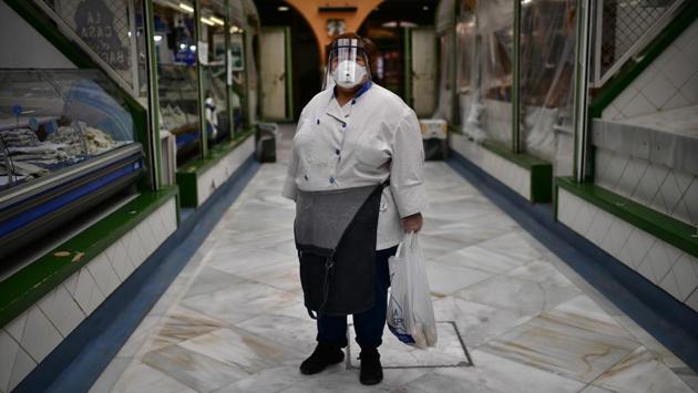 Juana Mari poses next to her fish market stall. (Alvaro Barrientos / AP)