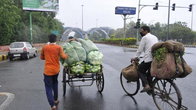 A vegetable vendor with produce loaded on a cycle cart, on the third day of the 3-week national lockdown to check the spread of coronavirus, in Noida, India, on March 27, 2020. (Sunil Ghosh / Hindustan Times) A vegetable vendor with produce loaded on a cycle cart, on the third day of the 3-week national lockdown to check the spread of coronavirus, in Noida, India, on March 27, 2020. (Sunil Ghosh / Hindustan Times)