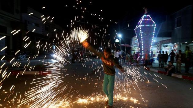 A Palestinian boy waves a homemade sparkler firework as he celebrates ahead of the holy fasting month, amid concerns about the spread of the coronavirus disease (COVID-19), in the southern Gaza Strip.(REUTERS) A Palestinian boy waves a homemade sparkler firework as he celebrates ahead of the holy fasting month, amid concerns about the spread of the coronavirus disease (COVID-19), in the southern Gaza Strip.(REUTERS)