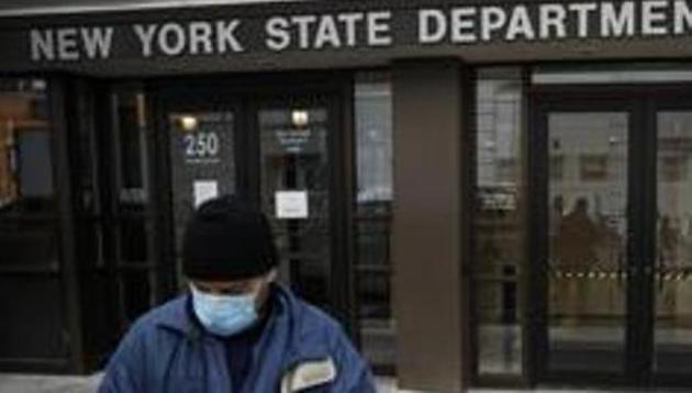 Visitors to the Department of Labor are turned away at the door by personnel due to closures over coronavirus concerns, Wednesday, March 18, 2020, in New York. (AP) Visitors to the Department of Labor are turned away at the door by personnel due to closures over coronavirus concerns, Wednesday, March 18, 2020, in New York. (AP)