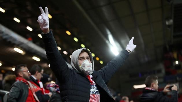 FILE PHOTO: Soccer Football - Champions League - Round of 16 Second Leg - Liverpool v Atletico Madrid - Anfield, Liverpool, Britain - March 11, 2020 An Atletico Madrid fan wearing a face mask inside the stadium before the match as the number of coronavirus cases grow around the world Action Images via Reuters/Carl Recine/File Photo (Action Images via Reuters) FILE PHOTO: Soccer Football - Champions League - Round of 16 Second Leg - Liverpool v Atletico Madrid - Anfield, Liverpool, Britain - March 11, 2020 An Atletico Madrid fan wearing a face mask inside the stadium before the match as the number of coronavirus cases grow around the world Action Images via Reuters/Carl Recine/File Photo (Action Images via Reuters)
