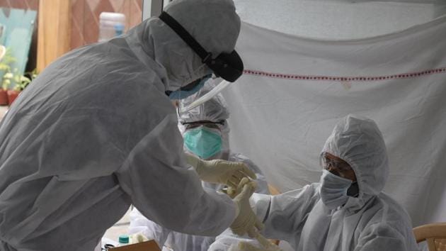 Medical workers collect samples from a Covid-19 test during a health camp organised for journalists, during lockdown to curb spread of coronavirus, at Patel Nagar, in New Delhi. Image used for representational purpose only.(Photo by Sonu Mehta/Hindustan Times)