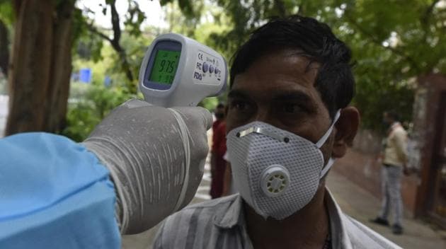 People are thermal screened by a worker in PPE overalls after the inauguration of 'Congress Ki Rasoi' by Delhi Pradesh Congress Committee (DPCC) President Anil Kumar, during the nationwide lockdown to curb the spread of coronavirus, at DPCC office, Rajiv Bhawan, ITO, in New Delhi India on Thursday, April 23, 2020. (Photo by Sonu Mehta/Hindustan Times) People are thermal screened by a worker in PPE overalls after the inauguration of 'Congress Ki Rasoi' by Delhi Pradesh Congress Committee (DPCC) President Anil Kumar, during the nationwide lockdown to curb the spread of coronavirus, at DPCC office, Rajiv Bhawan, ITO, in New Delhi India on Thursday, April 23, 2020. (Photo by Sonu Mehta/Hindustan Times)