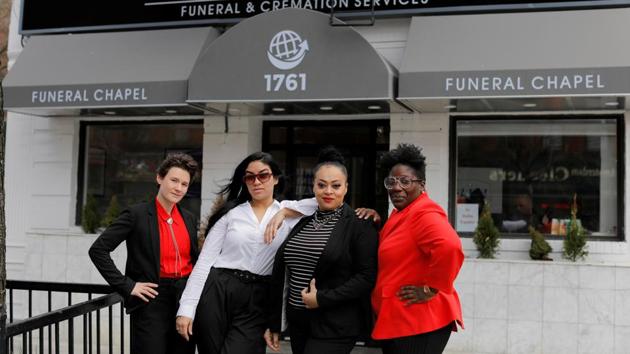 (Left to right): Lily Sage Weinrieb, Alisha Narvaez, Jenny Adames and Nicole Warring, outside their office, in Manhattan. As health officials began burying COVID-19 victims in a mass grave on Hart Island during New York’s worst week of death, the four women undertakers started turning bodies away. The way they see it, a person should get what they want in death, even if that was never possible in life. (Andrew Kelly / REUTERS) (Left to right): Lily Sage Weinrieb, Alisha Narvaez, Jenny Adames and Nicole Warring, outside their office, in Manhattan. As health officials began burying COVID-19 victims in a mass grave on Hart Island during New York’s worst week of death, the four women undertakers started turning bodies away. The way they see it, a person should get what they want in death, even if that was never possible in life. (Andrew Kelly / REUTERS)