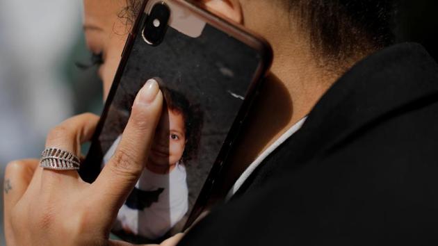 Jenny Adames speaks on her phone that features an image of her daughter who is currently in quarantine at her grandmother’s house. She recently caught herself snapping at her in a text exchange. “Today kind of broke my heart.” “She needs her mom. She doesn’t need Jenny the funeral director,” Adames told Reuters. (Andrew Kelly / REUTERS) Jenny Adames speaks on her phone that features an image of her daughter who is currently in quarantine at her grandmother’s house. She recently caught herself snapping at her in a text exchange. “Today kind of broke my heart.” “She needs her mom. She doesn’t need Jenny the funeral director,” Adames told Reuters. (Andrew Kelly / REUTERS)