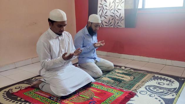 Syed Khalil (white) and Umar Shaikh (blue) offer prayers at home on Thursday.(Shankar Narayan/HT PHOTO)