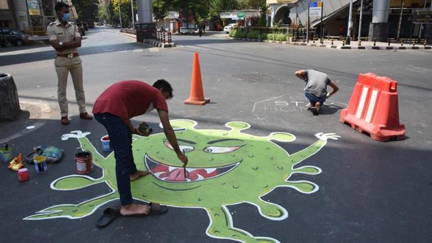 Mumbai, India 11 April. 20: Artist painting message of Corona virus on road at Nana chowk, to spread the awareness of Covid 19 during nation wide lockdown due to Covid-19 spread in Mumbai, India, on Saturday, 11 April, 2020. (Photo by ) (Bhushan Koyande/ HT) Mumbai, India 11 April. 20: Artist painting message of Corona virus on road at Nana chowk, to spread the awareness of Covid 19 during nation wide lockdown due to Covid-19 spread in Mumbai, India, on Saturday, 11 April, 2020. (Photo by ) (Bhushan Koyande/ HT)