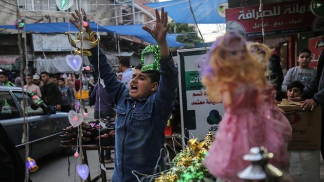 A young Palestinian seller showcases Chinese-made “fanous” lanterns, used to celebrate the start of Ramzan, at a stall in Khan Yunis. (Said Khatib / AFP) A young Palestinian seller showcases Chinese-made “fanous” lanterns, used to celebrate the start of Ramzan, at a stall in Khan Yunis. (Said Khatib / AFP)