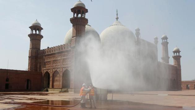 Volunteers disinfects the historical Badshahi Mosque in Lahore, Pakistan, on April 22, 2020. Irrespective of the nature of restrictions in their part of the world, Muslims all around are trying to work out how to maintain the many cherished rituals of this holiest of months. (K.M Chudhry / AP) Volunteers disinfects the historical Badshahi Mosque in Lahore, Pakistan, on April 22, 2020. Irrespective of the nature of restrictions in their part of the world, Muslims all around are trying to work out how to maintain the many cherished rituals of this holiest of months. (K.M Chudhry / AP)