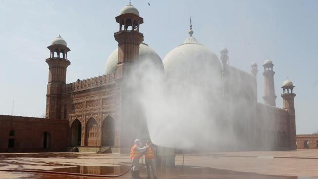 Volunteers disinfects the historical Badshahi Mosque ahead of the Muslim fasting month of Ramadan, in Lahore, Pakistan, Wednesday, April 22, 2020. (AP) Volunteers disinfects the historical Badshahi Mosque ahead of the Muslim fasting month of Ramadan, in Lahore, Pakistan, Wednesday, April 22, 2020. (AP)
