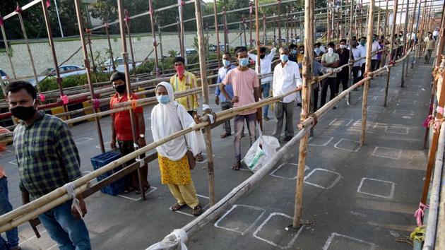 Covid-19 in India: People maintain social distance as they queue to enter a fruit market during the Covid-19 lockdown, in Navi Mumbai on Friday. (PTI Photo) Covid-19 in India: People maintain social distance as they queue to enter a fruit market during the Covid-19 lockdown, in Navi Mumbai on Friday. (PTI Photo)