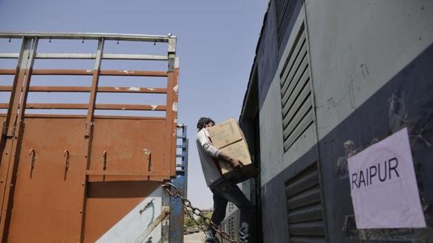 Covid-19 update: An Indian worker loads cartons of milk powder in a parcel train during lockdown as a precautionary measure against coronavirus in Ahmedabad, India. Image used for representational purpose. (AP) Covid-19 update: An Indian worker loads cartons of milk powder in a parcel train during lockdown as a precautionary measure against coronavirus in Ahmedabad, India. Image used for representational purpose. (AP)