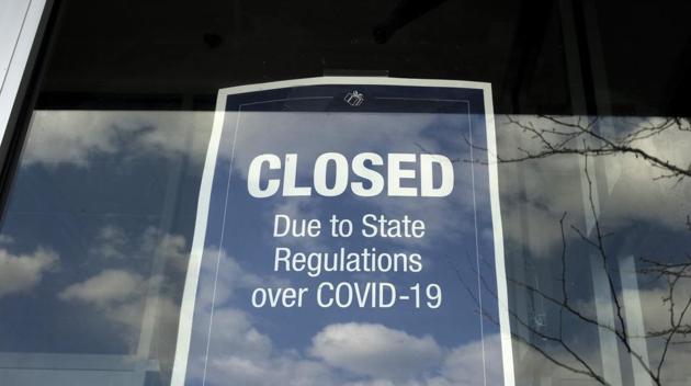 In this Wednesday, April 22, 2020 photo a closed sign is posted in the window of a store because of the coronavirus, in an outdoor mall, in Dedham, Massachusetts. (AP) In this Wednesday, April 22, 2020 photo a closed sign is posted in the window of a store because of the coronavirus, in an outdoor mall, in Dedham, Massachusetts. (AP)