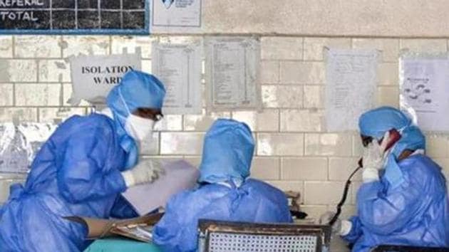 Medics outside an isolation ward of the novel coronavirus at a hospital. (PTI) Medics outside an isolation ward of the novel coronavirus at a hospital. (PTI)