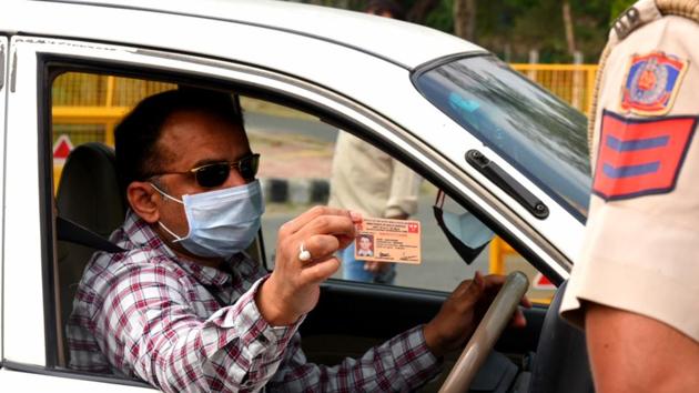 A commuter shows his identity card after being stopped by the Uttar Pradesh Police personnel at Delhi-Noida border after it was sealed during lockdown, near Mayur Vihar, iNew Delhi, April 23, 2020. (Sonu Mehta / HT Photo) A commuter shows his identity card after being stopped by the Uttar Pradesh Police personnel at Delhi-Noida border after it was sealed during lockdown, near Mayur Vihar, iNew Delhi, April 23, 2020. (Sonu Mehta / HT Photo)