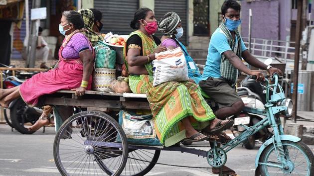 Women travel by a rickshaw as they return after buying daily essentials during the coronavirus lockdown in Vijayawada on Saturday. (ANI Photo) (ANI) Women travel by a rickshaw as they return after buying daily essentials during the coronavirus lockdown in Vijayawada on Saturday. (ANI Photo) (ANI)