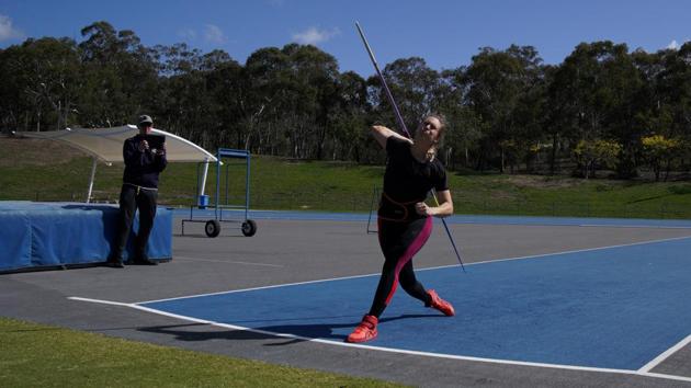Kelsey-Lee Barber trains as Mike Barber keeps record of her throws. It has been nearly seven months since she snatched her maiden world title with a clean final-round throw at Doha in October. (Loren Elliott / REUTERS)