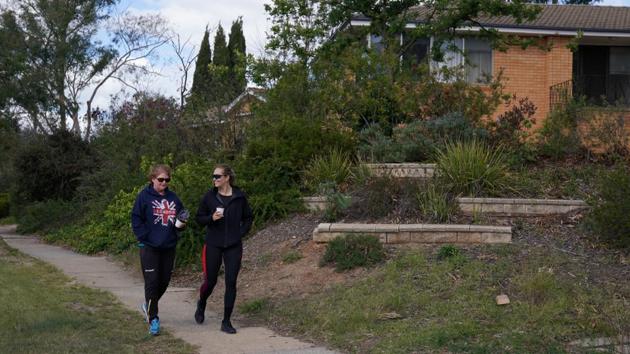 Kelsey-Lee Barber (R) drinks coffee and takes a walk with mother Bev Roberts due to cafes only being open for take-away. The lack of opportunity to compete as a world champion would be a bitter pill to swallow but it has not lessened her determination. (Loren Elliott / REUTERS)