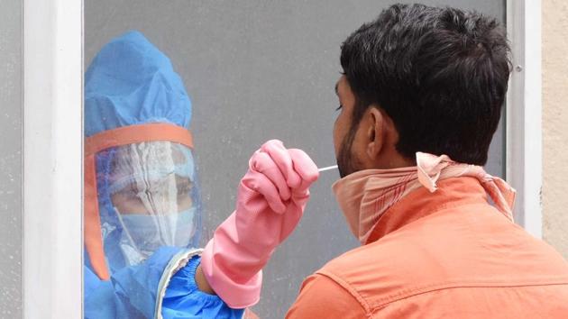 A health worker collects swabs for rapid testing in Hindpirhi locality, a coronavirus containment zone in Ranchi, Jharkhand. (Diwakar Prasad/ Hindustan Times) A health worker collects swabs for rapid testing in Hindpirhi locality, a coronavirus containment zone in Ranchi, Jharkhand. (Diwakar Prasad/ Hindustan Times)